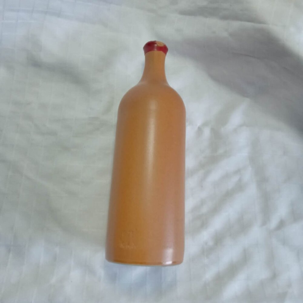 B) Two empty alcohol bottles for artistic creations, one with cap